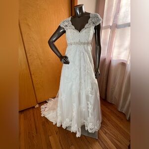 Ivory David’s Bridal style T3299 A-line lace empire waist gown.